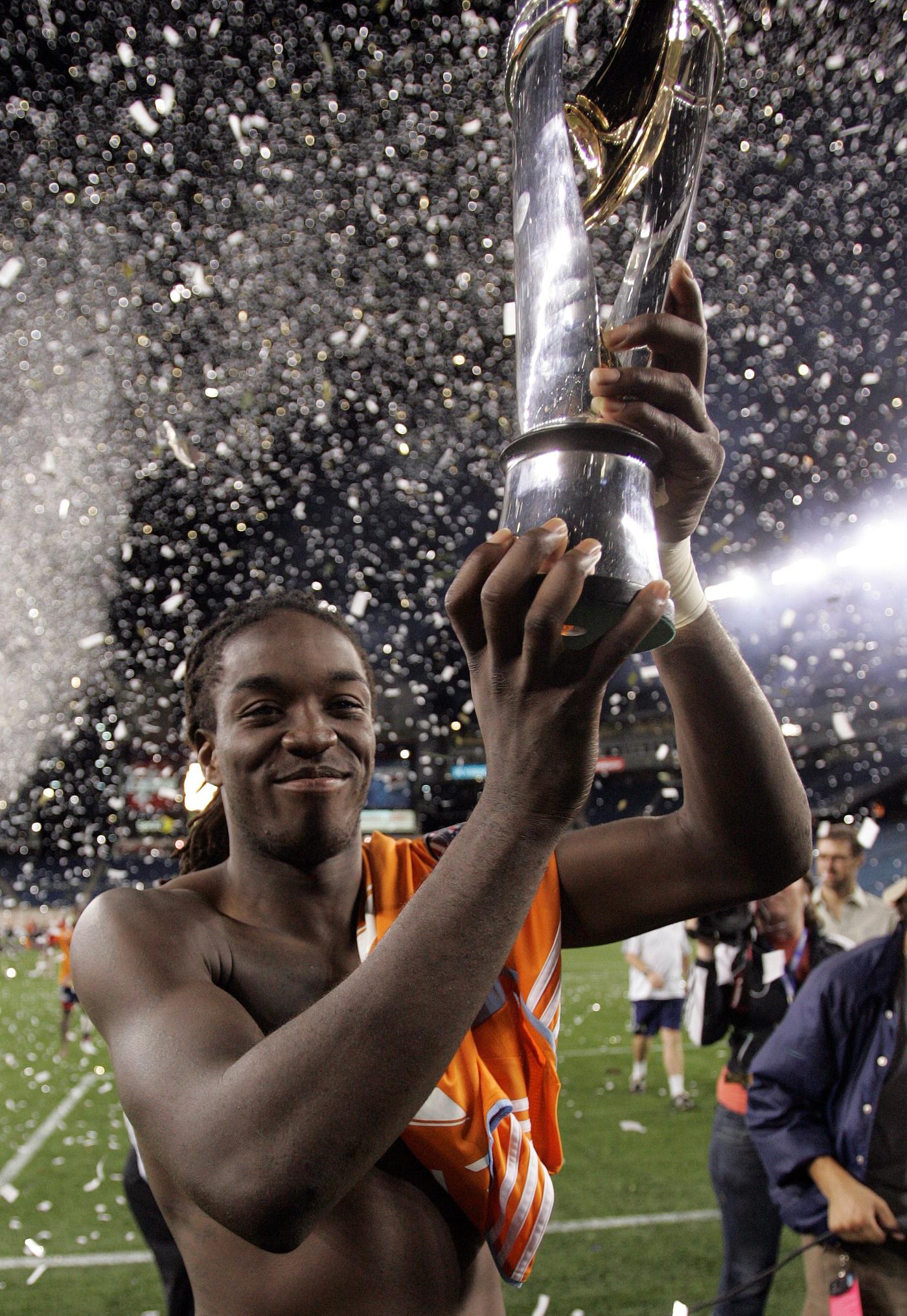 Shalrie Joseph holds the SuperLiga 2008 trophy aloft after the Revs defeated the Houston Dynamo in penalty kicks.